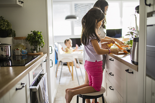 Mom and kids meal prepping at home