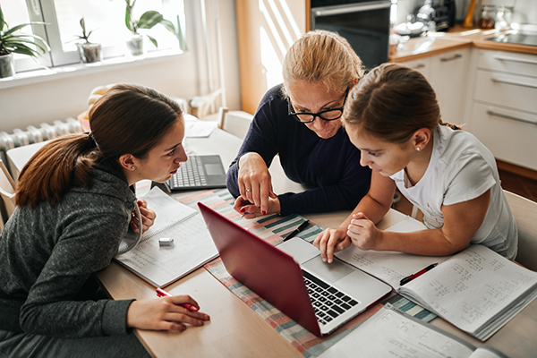 Mom helping daughters with remote learning