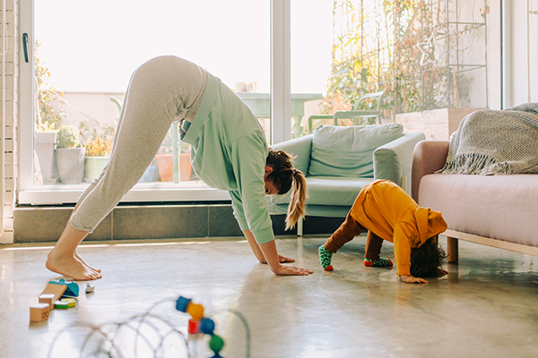 Photo of mom and baby boy doing yoga together