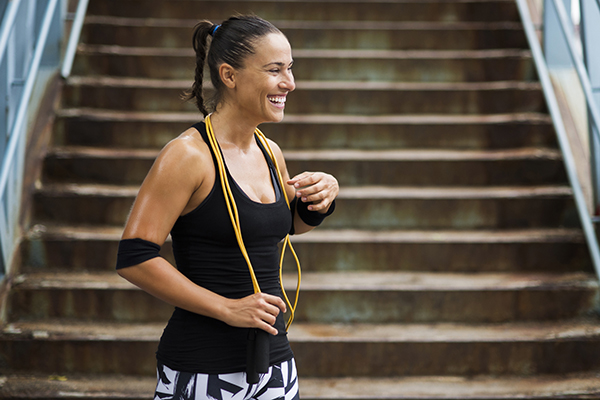 Woman smiling after jump rope workout
