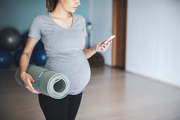 Pregnant woman preparing for exercises at home