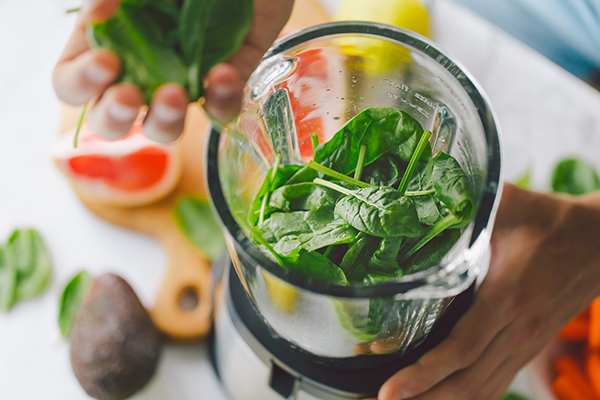 Making a smoothie with spinach