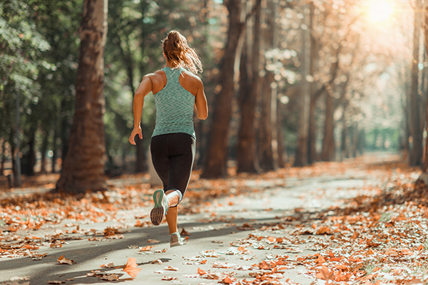 Woman Jogging Outdoors In Autumn