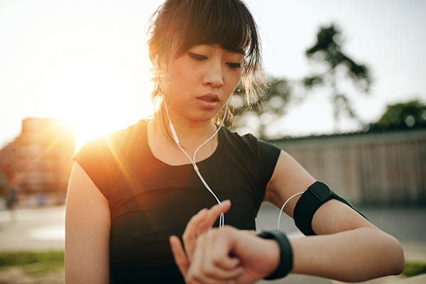 Runner looking at smartwatch.