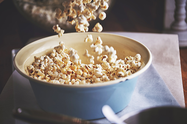 Popcorn pouring into a bowl