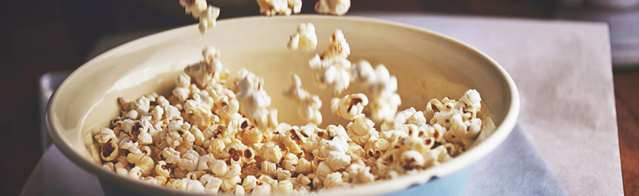 Popcorn pouring into a bowl