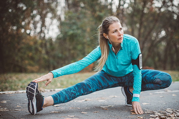 Woman stretching her leg outdoors