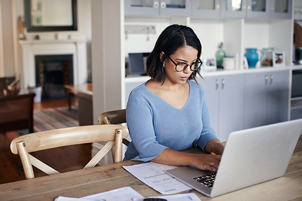 young woman using a laptop while working from home