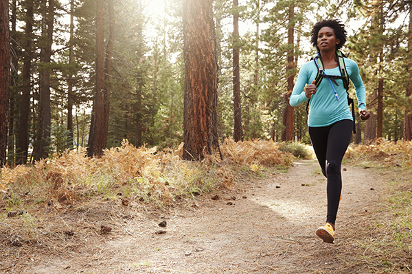 Woman trail running in the forest