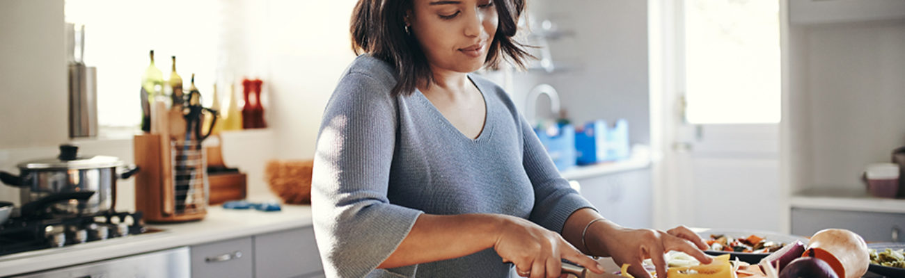 young woman cooking at home