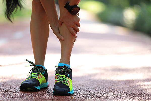 Runner gripping painful shin