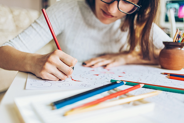 Woman coloring in coloring book