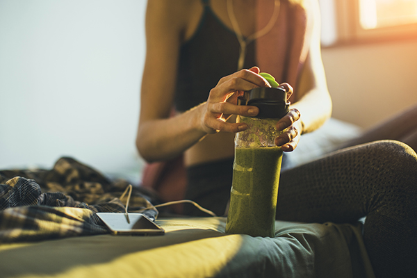 Woman drinking smoothie after a run