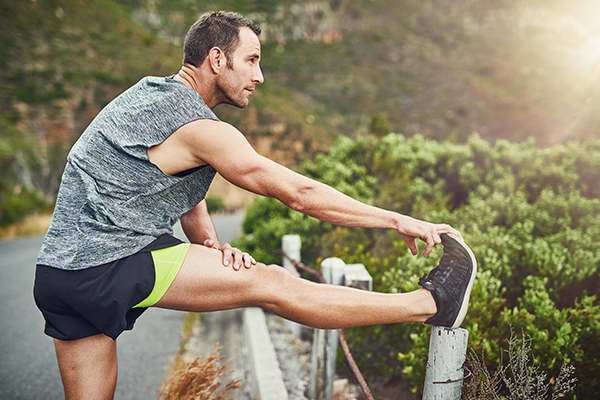 Man stretching leg after a run