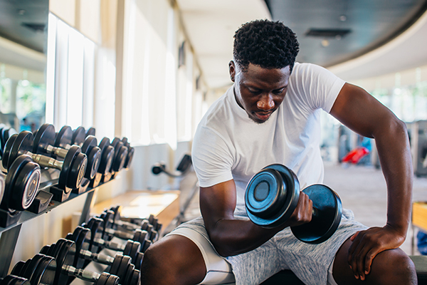 Man lifting dumbbell at a gym