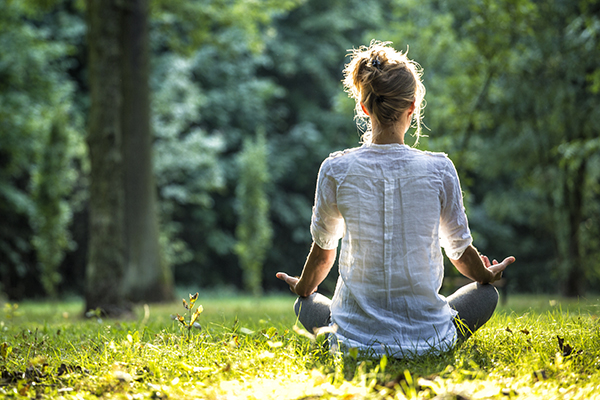 Woman meditating outside