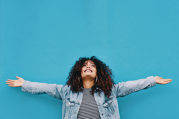 Happy woman holding out arms