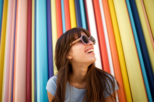 Close up of cheerful young woman laughing.