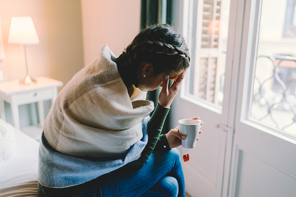 Anxious woman sitting down at home