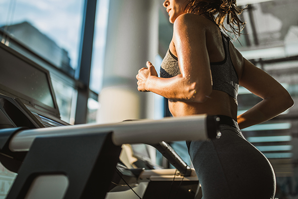 Woman running on treadmill.