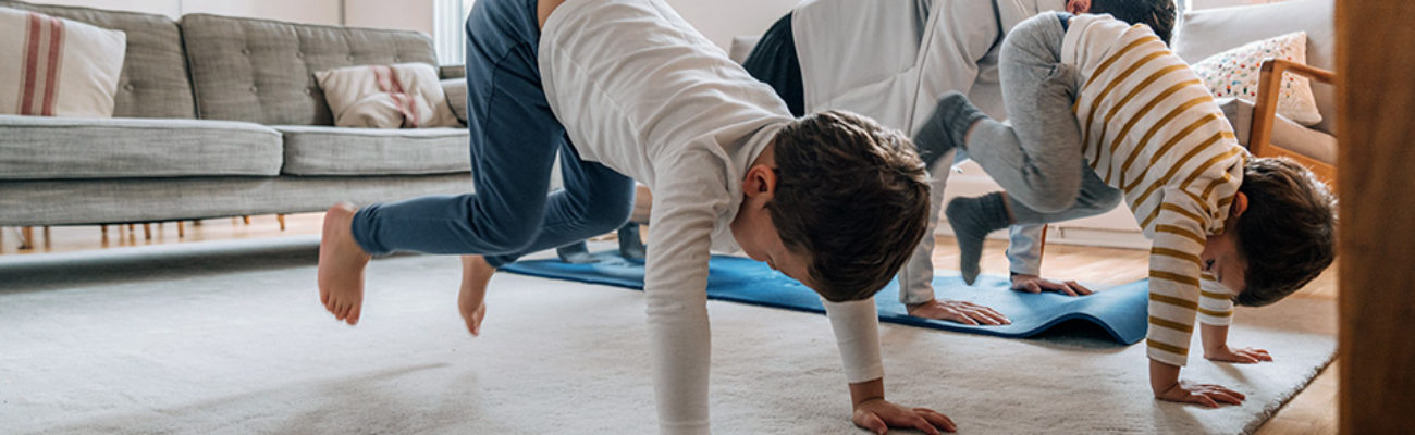 Dad exercising with kids at home