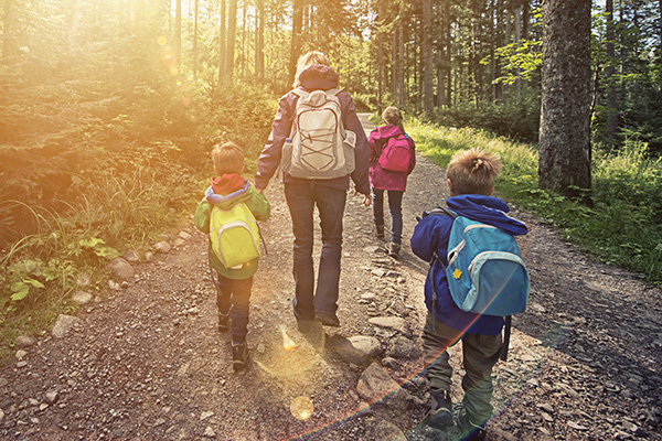 Mom and kids hiking in the woods