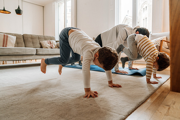 Father with children exercising at home