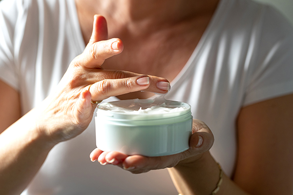 Woman holding jar of aloe vera lotion