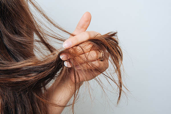 Woman's hand holding her hair