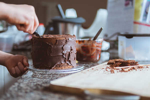 Woman icing a cake at home