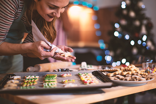 woman decorating holiday cookies