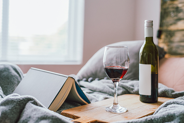 Glass of wine next to a wine bottle