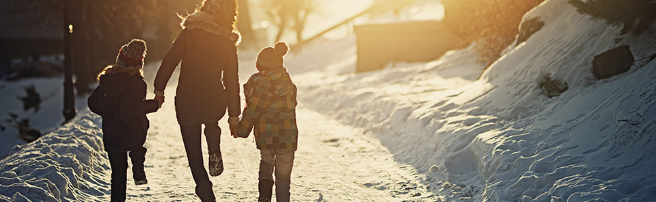 Family running in the snow