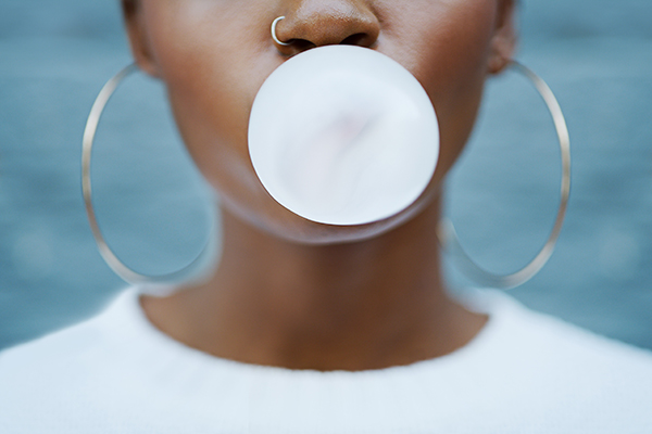 Woman blowing a chewing gum bubble
