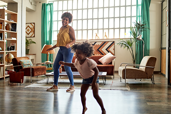 Mother and daughter dancing at home