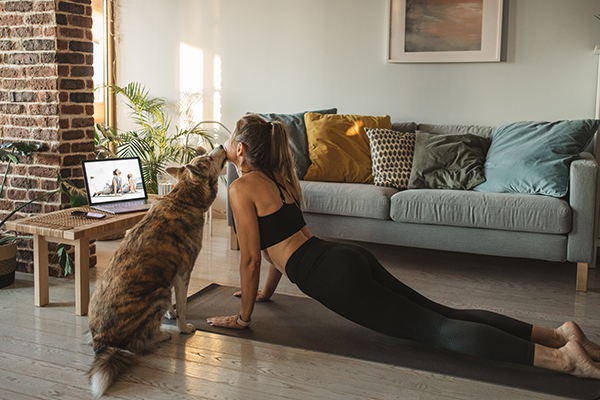 Woman doing streaming yoga workout at home