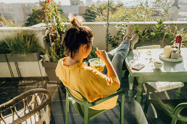 Woman eating lunch on balcony