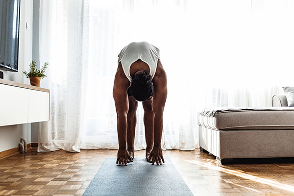 Man doing hamstring stretch at home