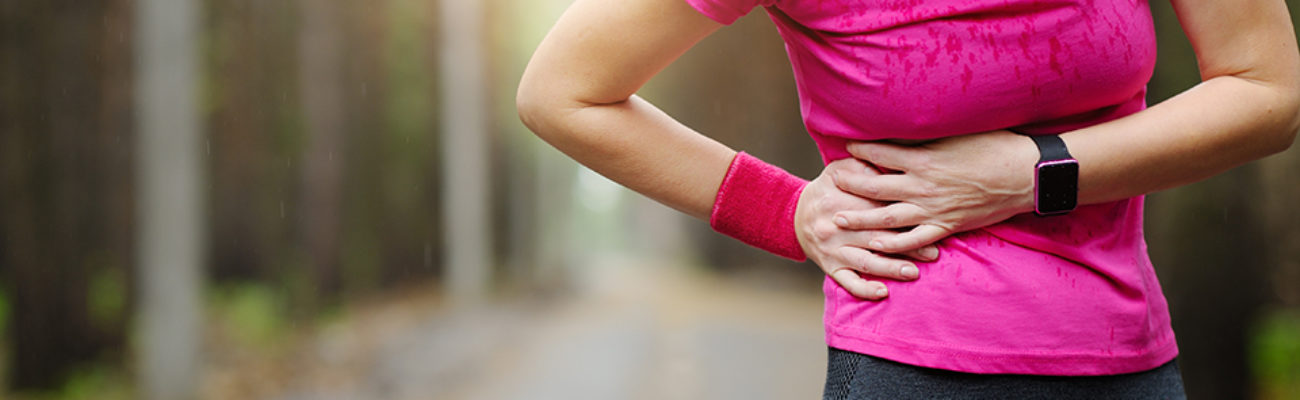 Woman runner with a side stitch