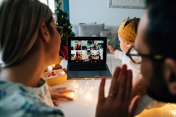 Family celebrating with relatives on Zoom call