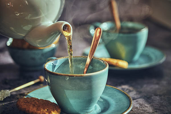 Pouring tea into tea cups
