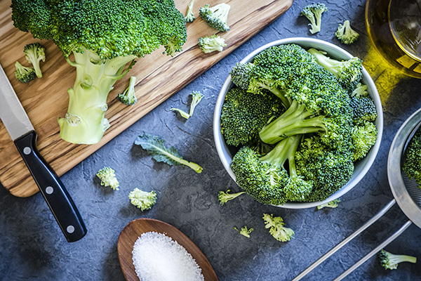 Overhead photo of broccoli stems in a bowl