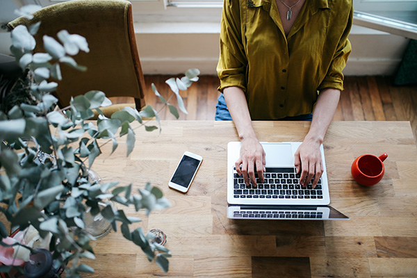 Woman typing in online gratitude journal