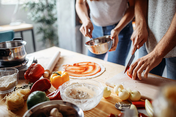 Couple preparing pizza at home