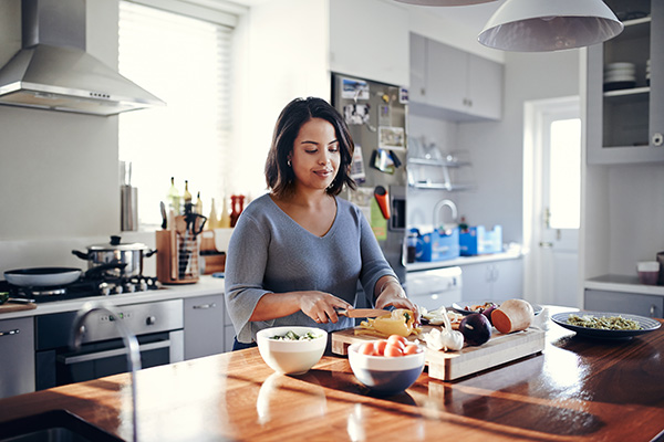 Young woman cooking at home