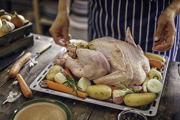 Preparing stuffed turkey with vegetables and other ingredients for holidays