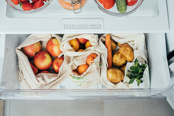 Reusable bags of vegetables, fruits in a fridge