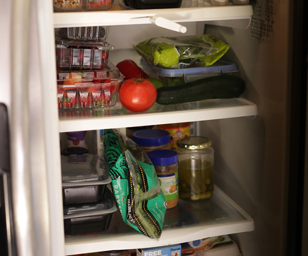 View of open fridge filled with food