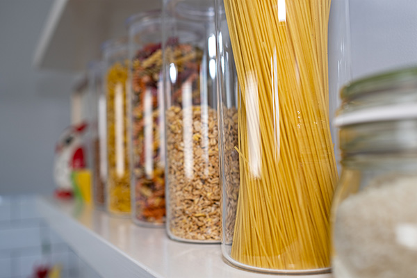 Plastic containers on pantry shelf