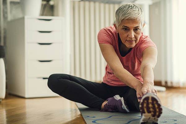 Woman stretching on the floor at home